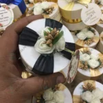 Round Bid Box With Off White Flowers & Black Ribbon