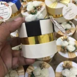 Round Bid Box With Off White Flowers & Black Ribbon