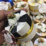 Round Bid Box With Off White Flowers & Black Ribbon