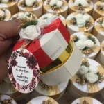 Round Bid Box With Red Ribbon and Flowers